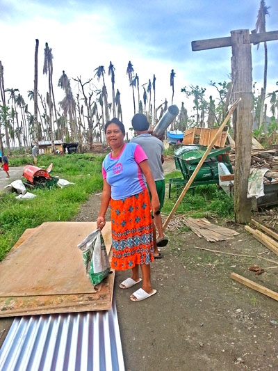 Eine Bewohnerin von Danao mit neuen Baumaterialien, die von den Spendengeldern gekauft wurden (c) Marilou Misagal-Bosshammer