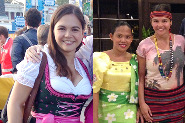 Eine Frau im Dirndl und zwei Frauen in philippinischer Tracht